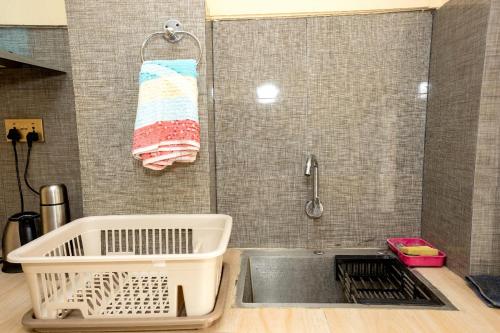 a kitchen with a sink and a shower with a towel at Kathmandu room with great view, like resort in Bālāju