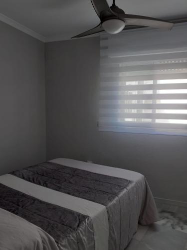 a bedroom with a bed and a ceiling fan at Cruz Del MAR in Chipiona