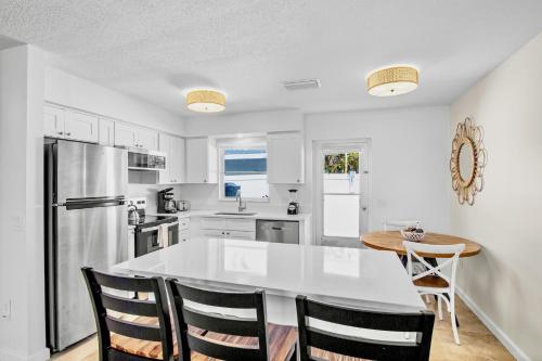 a white kitchen with a table and chairs at Southern Breeze 2 in Anna Maria