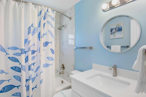a bathroom with a blue and white shower curtain at Southern Breeze 2 in Anna Maria