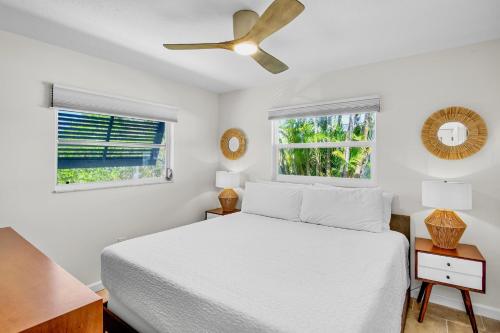 a bedroom with a white bed and a ceiling fan at Southern Breeze 2 in Anna Maria