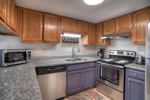 a kitchen with wooden cabinets and stainless steel appliances at 2 2 Ferringway 26 in Durango