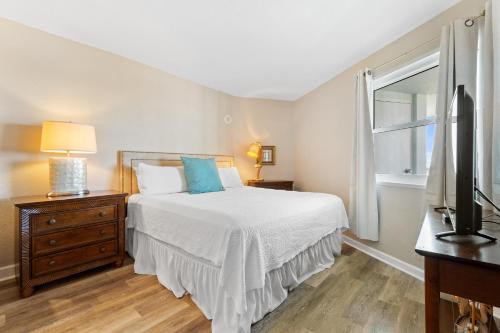 a bedroom with a bed and a window and a television at Perdido Sun 1010 in Perdido Key