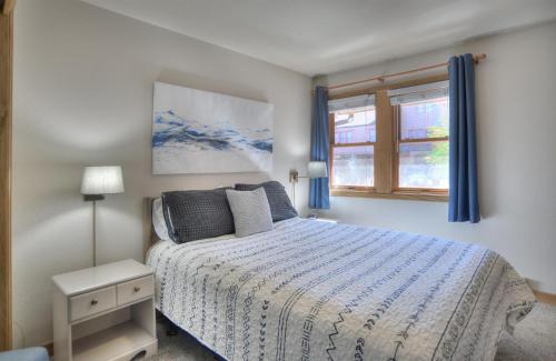 a bedroom with a bed and two windows at 2 2 Ferringway 26 in Durango