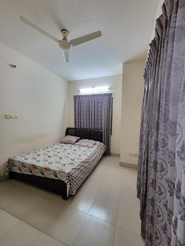 a bedroom with a bed and a window with curtains at Budget Double Bed Single Room by Dhaka Airport Terminal 3 in Dhaka