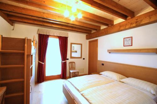 a bedroom with a bed and a window at Affittacamere Alle Trote in Sùtrio