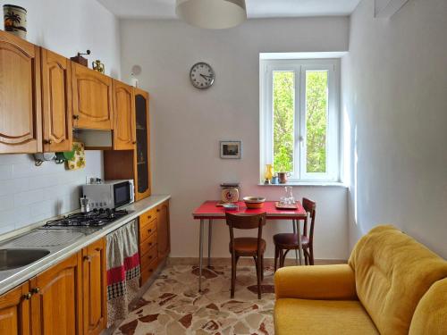a kitchen with a table and a small table with chairs at Dazicalò in San Giovanni Gemini
