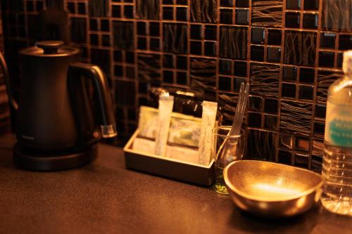 a kitchen counter with a container of soap and a bowl at Funaya Raku 樂 in Kameshima