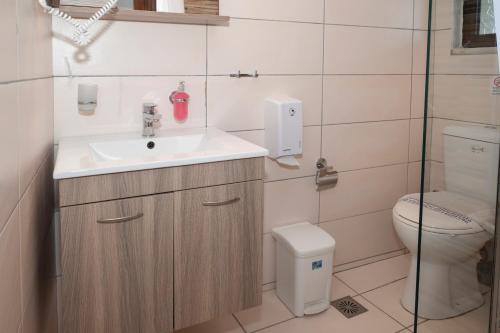 a bathroom with a sink and a toilet at Argo Rooms-Papadakis in Kissamos