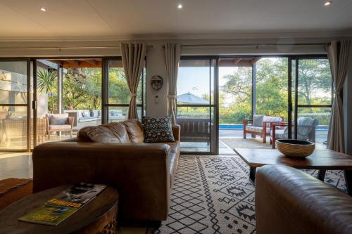 a living room with a couch and a table at Rafiki Bush Lodge in Hoedspruit