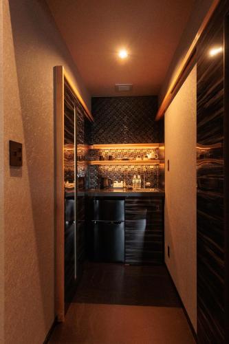 a small kitchen with a bar in a room at Funaya Raku 樂 in Kameshima