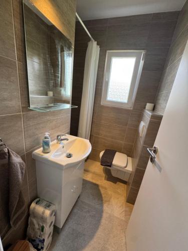a bathroom with a sink and a toilet at Budatava Vendégház in Balatonalmádi