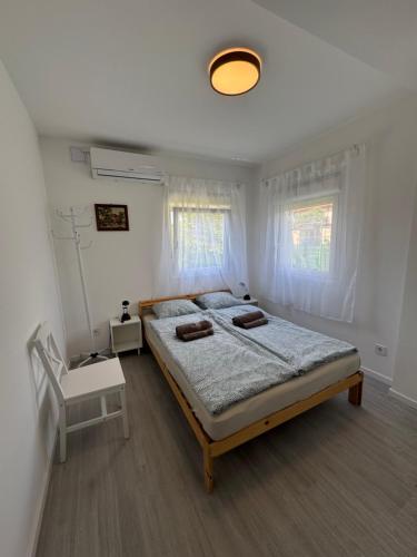 a bedroom with a large bed in a room at Budatava Vendégház in Balatonalmádi