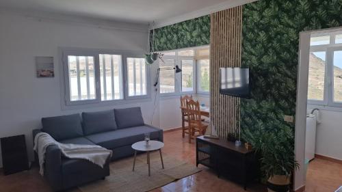 a living room with a couch and a table at Villa Vargas Paraiso in Carrizal