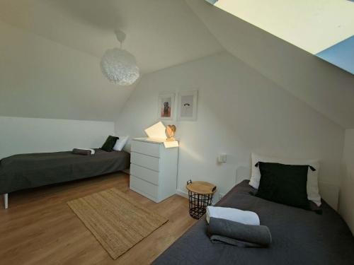 a attic bedroom with a bed and a night stand at Domki Czarny Bocian in Białogóra