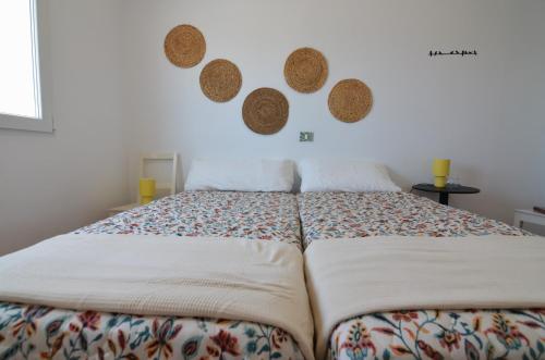 a bedroom with a large bed and two mirrors on the wall at Villa Vargas Paraiso in Carrizal