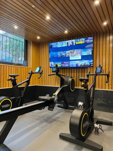 a gym with two exercise bikes and a flat screen tv at Richmond Hill Hotel in Richmond upon Thames