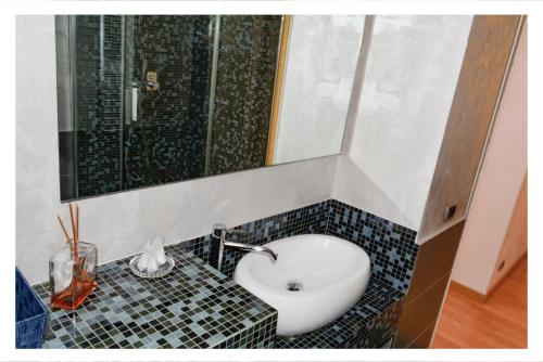 a bathroom with a sink and a mirror at Ostia Holiday La Marina in Lido di Ostia
