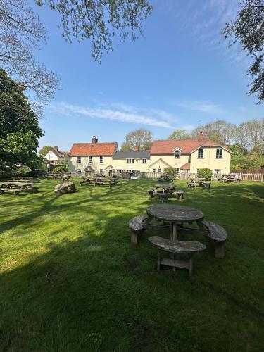 a group of picnic tables in a field at Black Horse in Brent Pelham