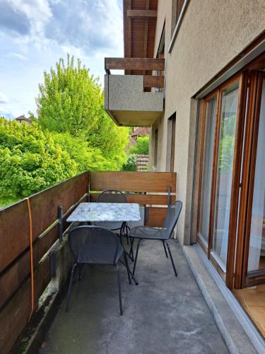 a patio with a table and chairs on a balcony at good bed Aarwangen in Aarwangen
