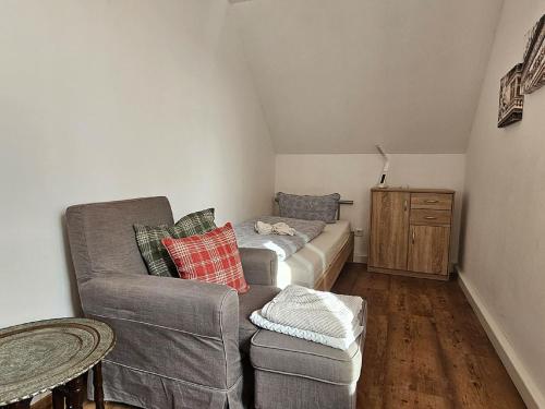 a living room with a couch and a chair at Ferienwohnung Martina in Sinzing
