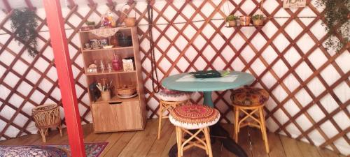 a room with a table and chairs in a yurt at La yourte Serenity des Volcans in Saint-Saturnin