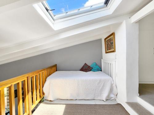 a bedroom with a bed with a skylight at The Loft on Tudor in Tokai