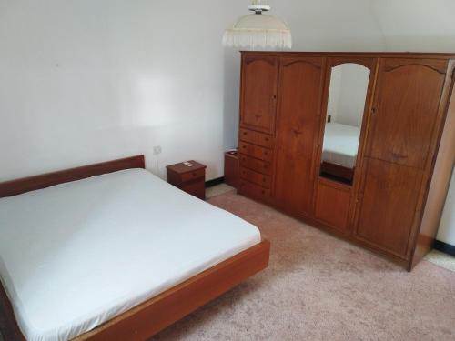 a bedroom with a bed and a dresser with a mirror at Coastal Villa in Mauritius