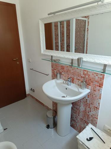 a bathroom with a sink and a mirror at Cosy apartment Aga in Collodi