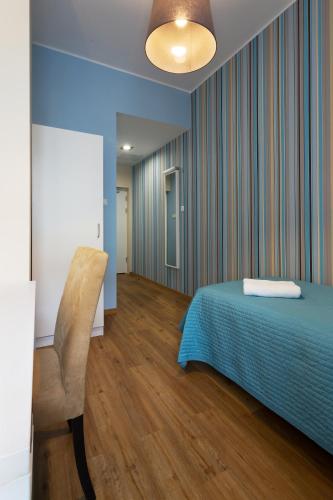 a bedroom with a bed and a chair in it at Hotel Traffic Poznań Stare Miasto in Poznań