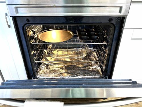 an oven with a spoon and some food in it at Cozy Walk up King Bed fast WiFi in Wilmington