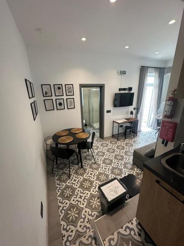 a living room with a table and a couch at Iris -Paola Modern Townhouse in Paola