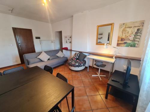 a living room with a couch and a table at Amazing escape in tuscany in Chiesina Uzzanese
