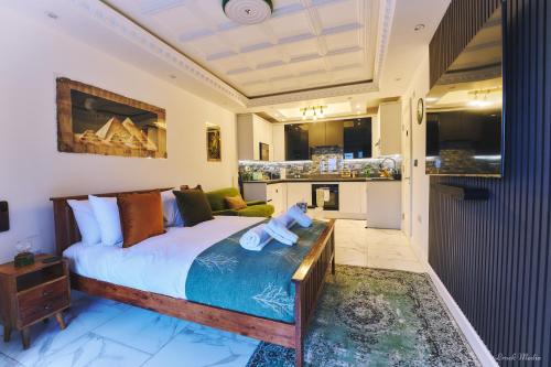 a bedroom with a bed and a living room at Luxury Studio in Wembley in Wembley