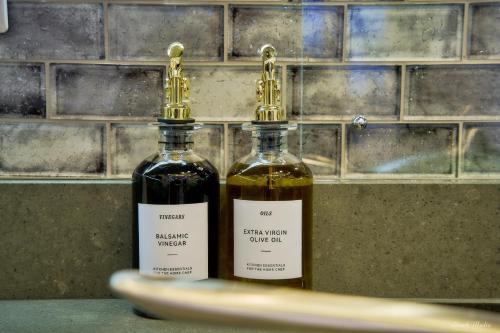 two bottles of wine sitting on top of a counter at Luxury Studio in Wembley in Wembley