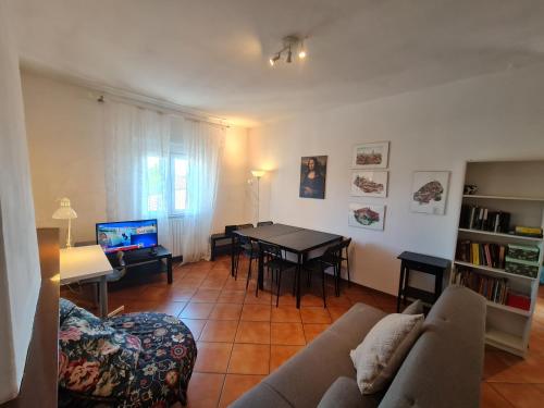 a living room with a couch and a table at Amazing escape in tuscany in Chiesina Uzzanese