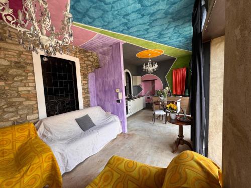 a room with a bed and a room with a painting on the ceiling at Casa storica Valentina in Monforte dʼAlba