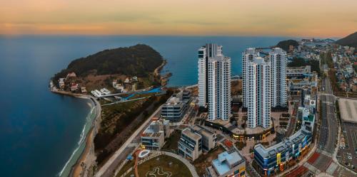 an aerial view of a city next to the ocean at Odays Osiria Residence in Busan