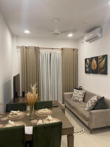 a living room with a couch and a table at Colombo, Trizen Luxury Apartments, Sri Lanka in Colombo