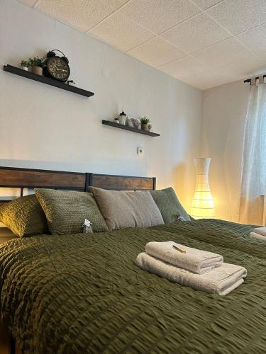 a bedroom with a bed with two towels on it at Landhaus Grinnerhof in Mehlingen
