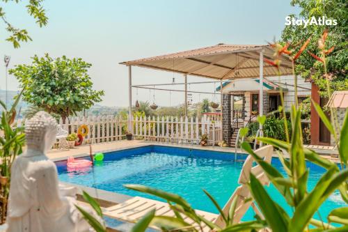 a villa with a swimming pool and a house at Nysa Villa & Homestay By StayAtlas in Igatpuri