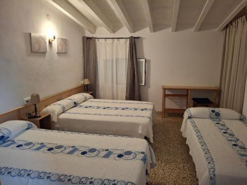 Postel nebo postele na pokoji v ubytování Hostal Pepe