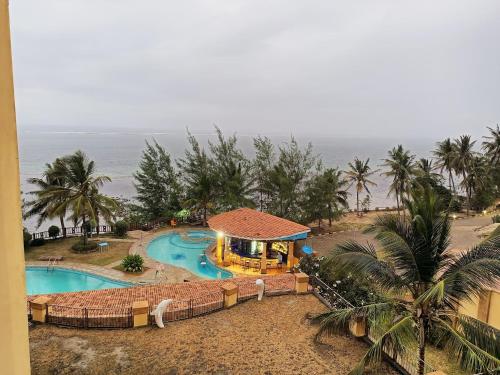 an aerial view of a resort with a swimming pool at Stunning beachfront 2 bedroom apartment in Mombasa