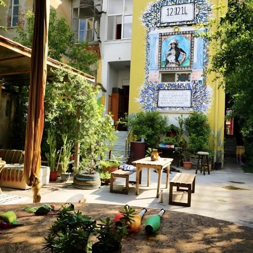 a courtyard with a table and chairs in a building at Tirana Backpacker Hostel in Tirana