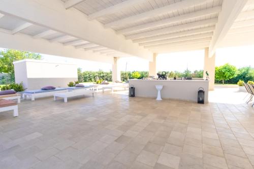 a large outdoor patio with couches and a table at Villa Brigida Resort in Santeramo in Colle
