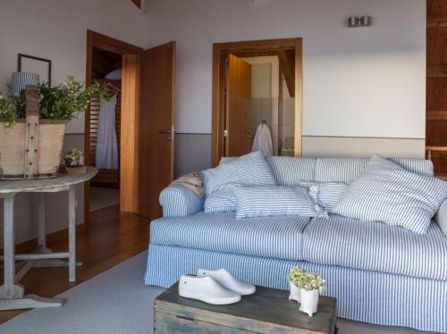 a living room with a blue couch and a table at Boavista Apartment in Praia da Vitória