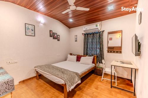 a bedroom with a bed and a ceiling fan at Nysa Villa & Homestay By StayAtlas in Igatpuri