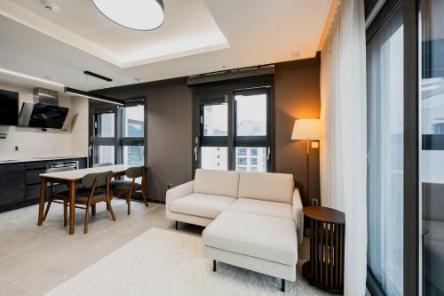 a living room with a couch and a table at Odays Osiria Residence in Busan