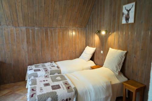 - une chambre avec 2 lits et une photo de cerf sur le mur dans l'établissement Villa Les Tilleuls, à Brides-les-Bains