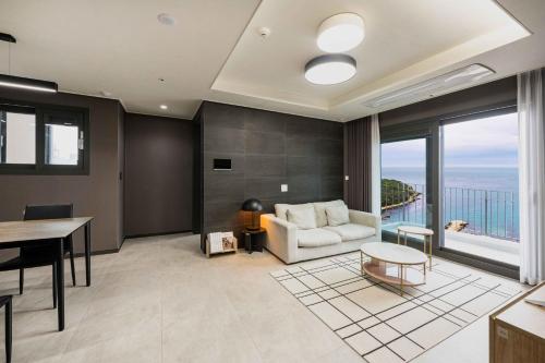 a living room with a couch and a table at Odays Osiria Residence in Busan